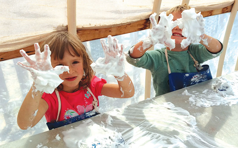 Santa Fe School of Arts & Sciences - Preschool students play with shaving cream